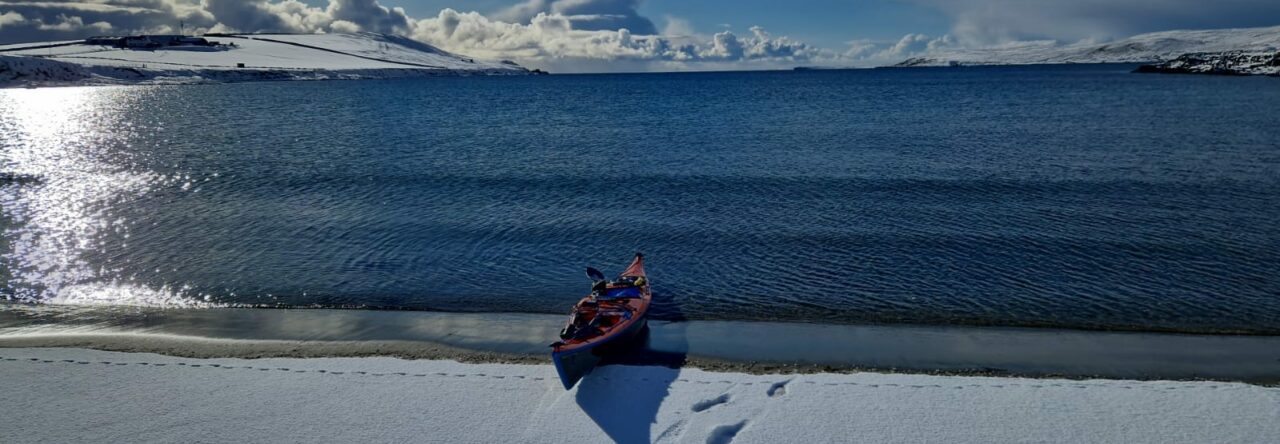 Kayak on a snowy Shetland beach, Shetland Canoe Club