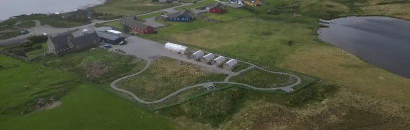 Aerial view of the Aald Skül community site, including the hub buildings, Polycrubs and outdoor paths
