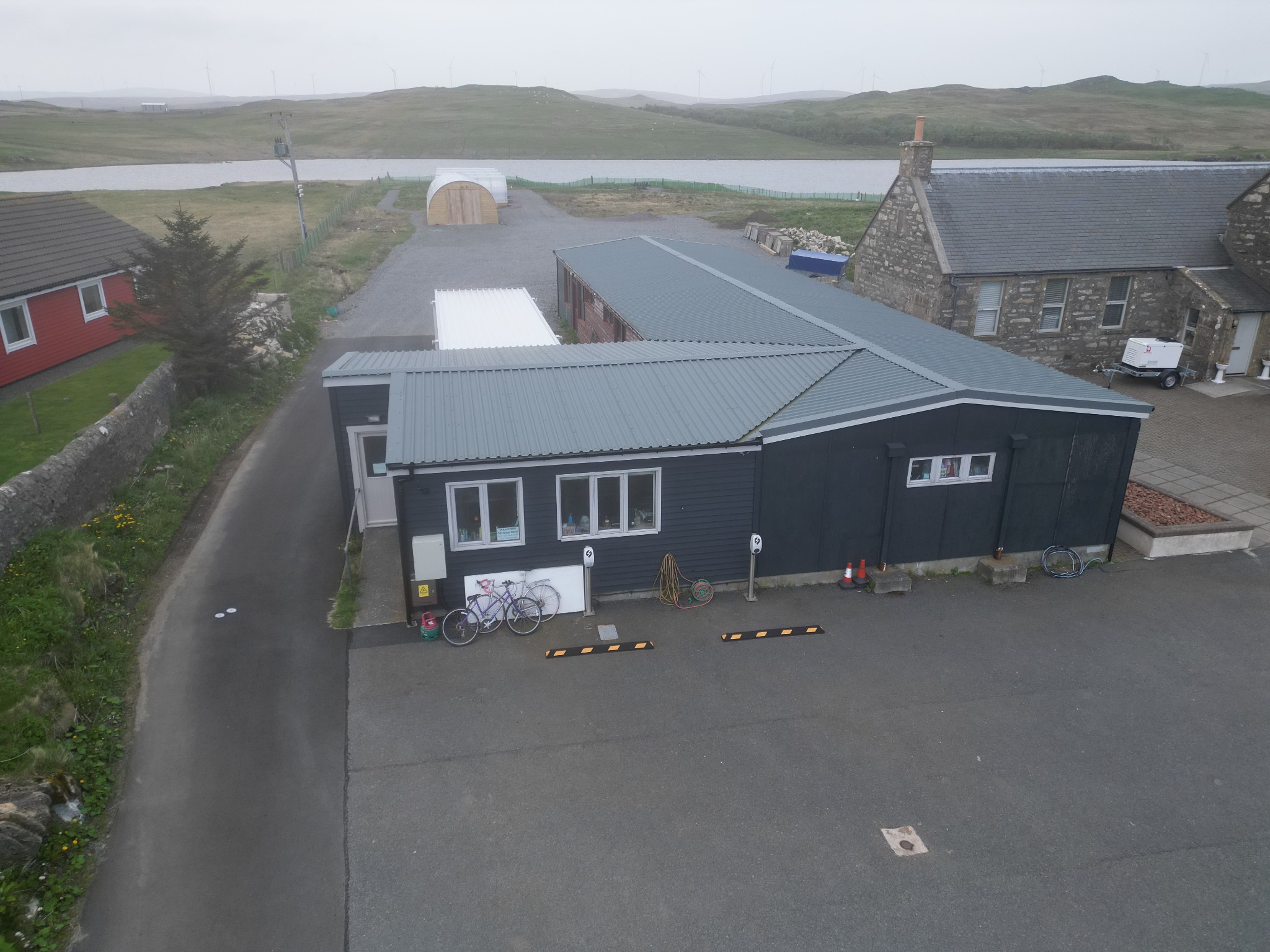 Aerial view of the Aald Skül community hub beside Benston Loch