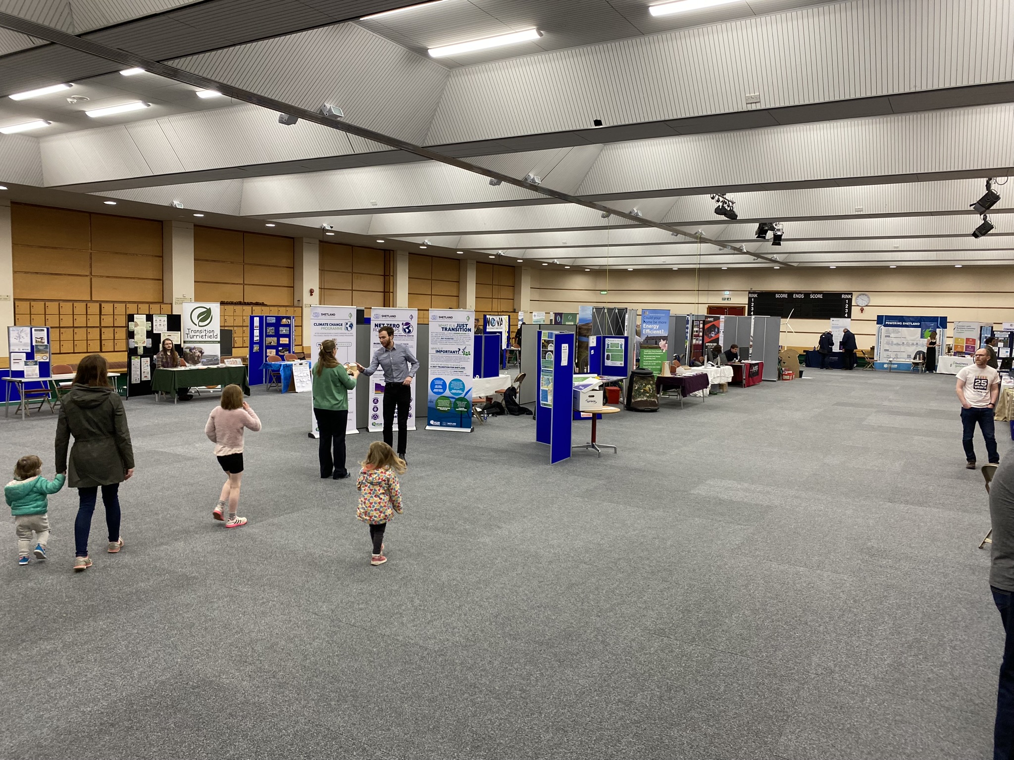 Visitors exploring the Shetland Climate Festival at Clickimin