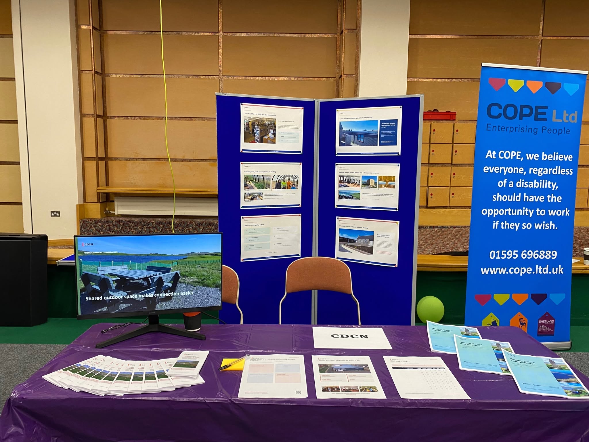 CDCN’s stall at the 2026 Shetland Climate Festival, with project displays, leaflets and a photo slideshow